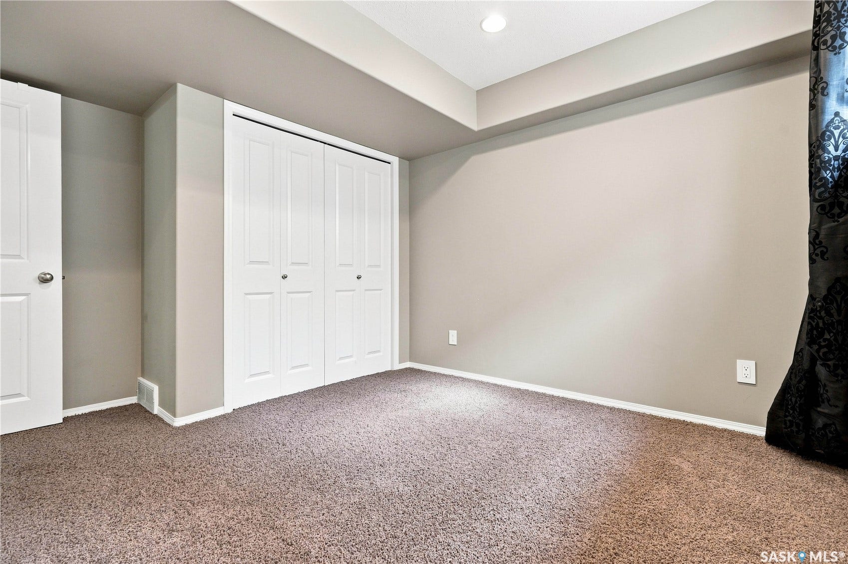 Recessed lighting, painted walls, carpeted flooring, and bi-fold closet doors
