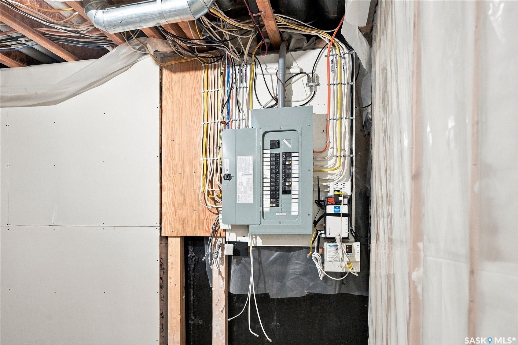 Electrical service panel with exposed wiring and ductwork
