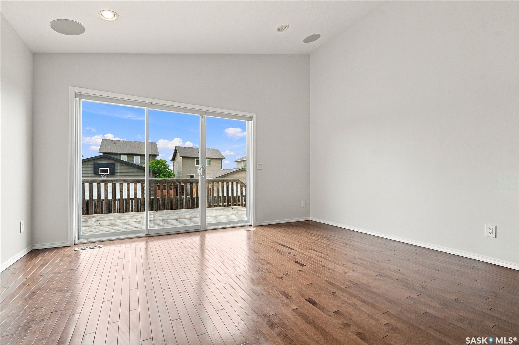 Hardwood flooring, recessed lighting, and built-in ceiling speakers