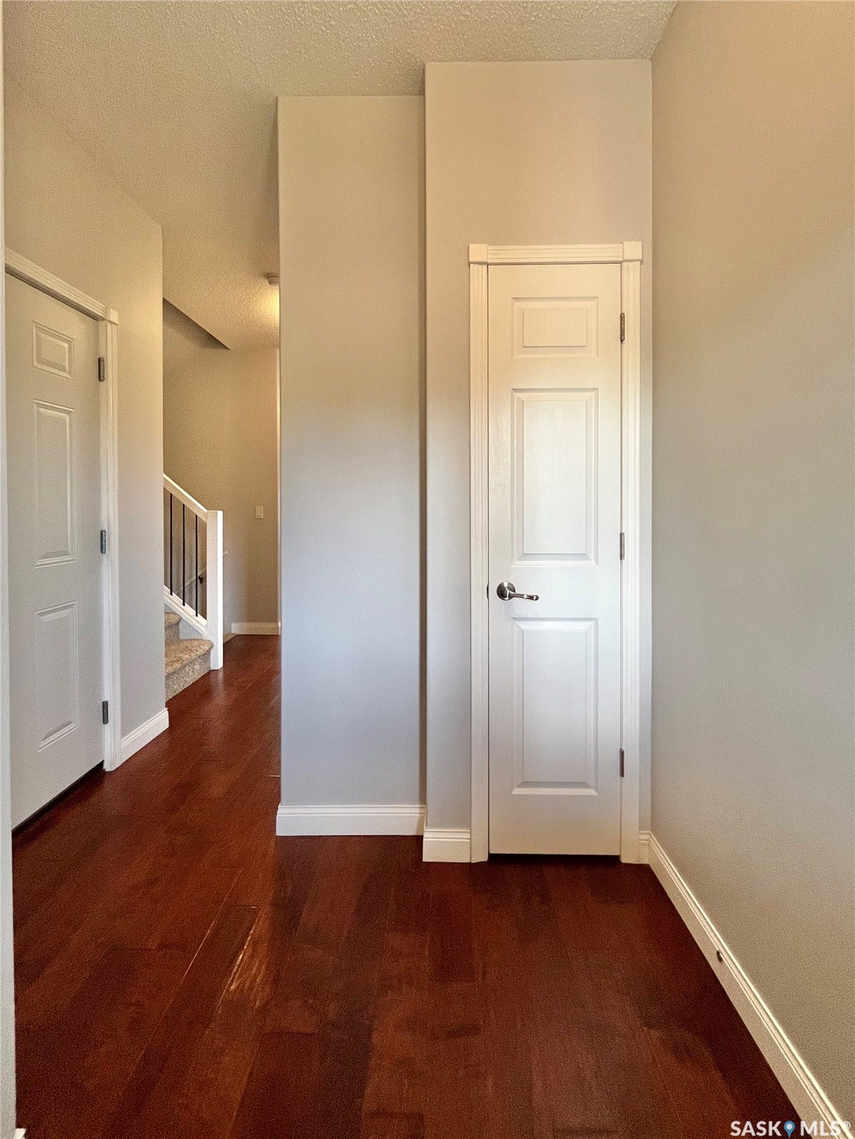 Warm wood-finish flooring with crisp white trim throughout