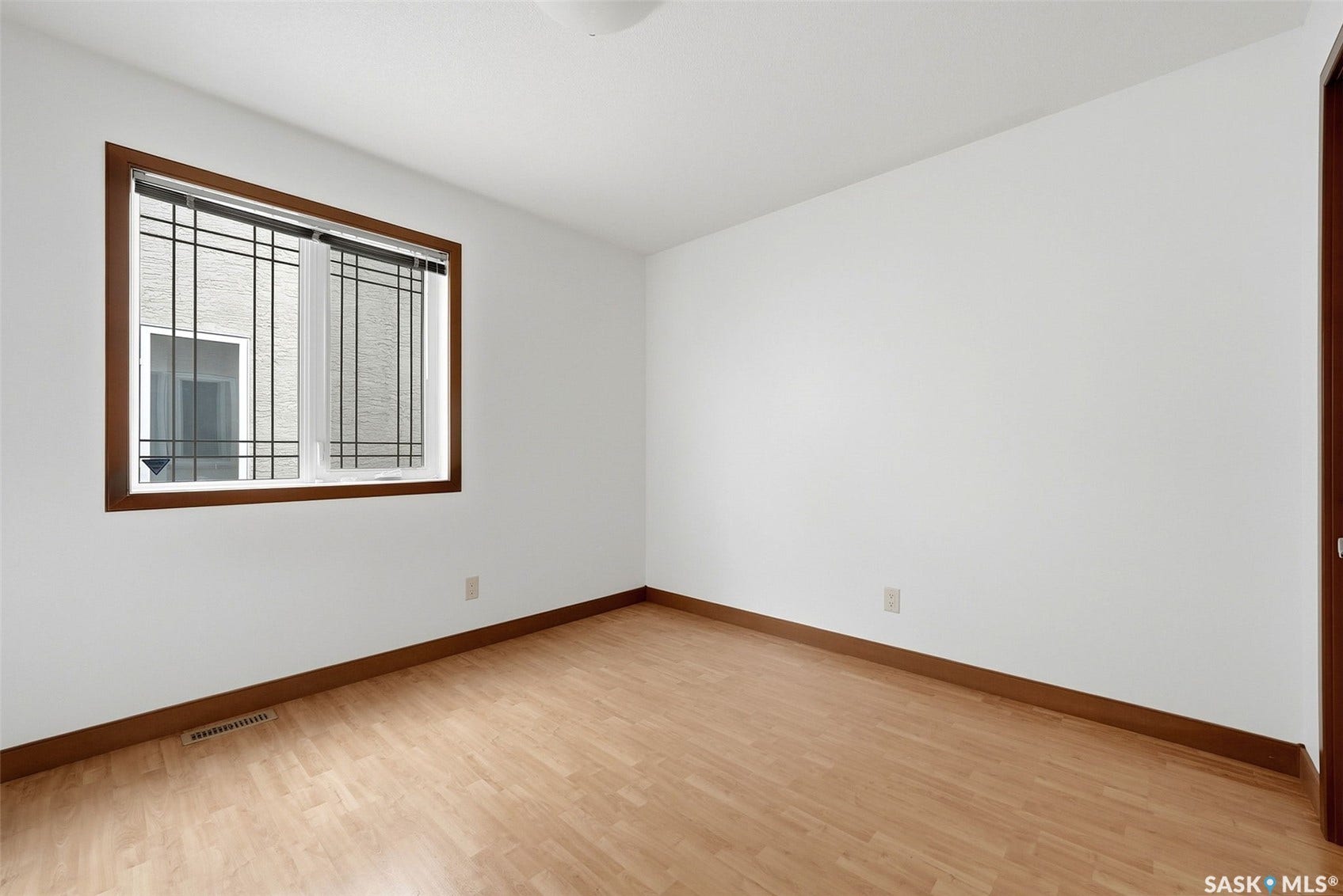 Light wood-finish flooring with coordinating baseboards