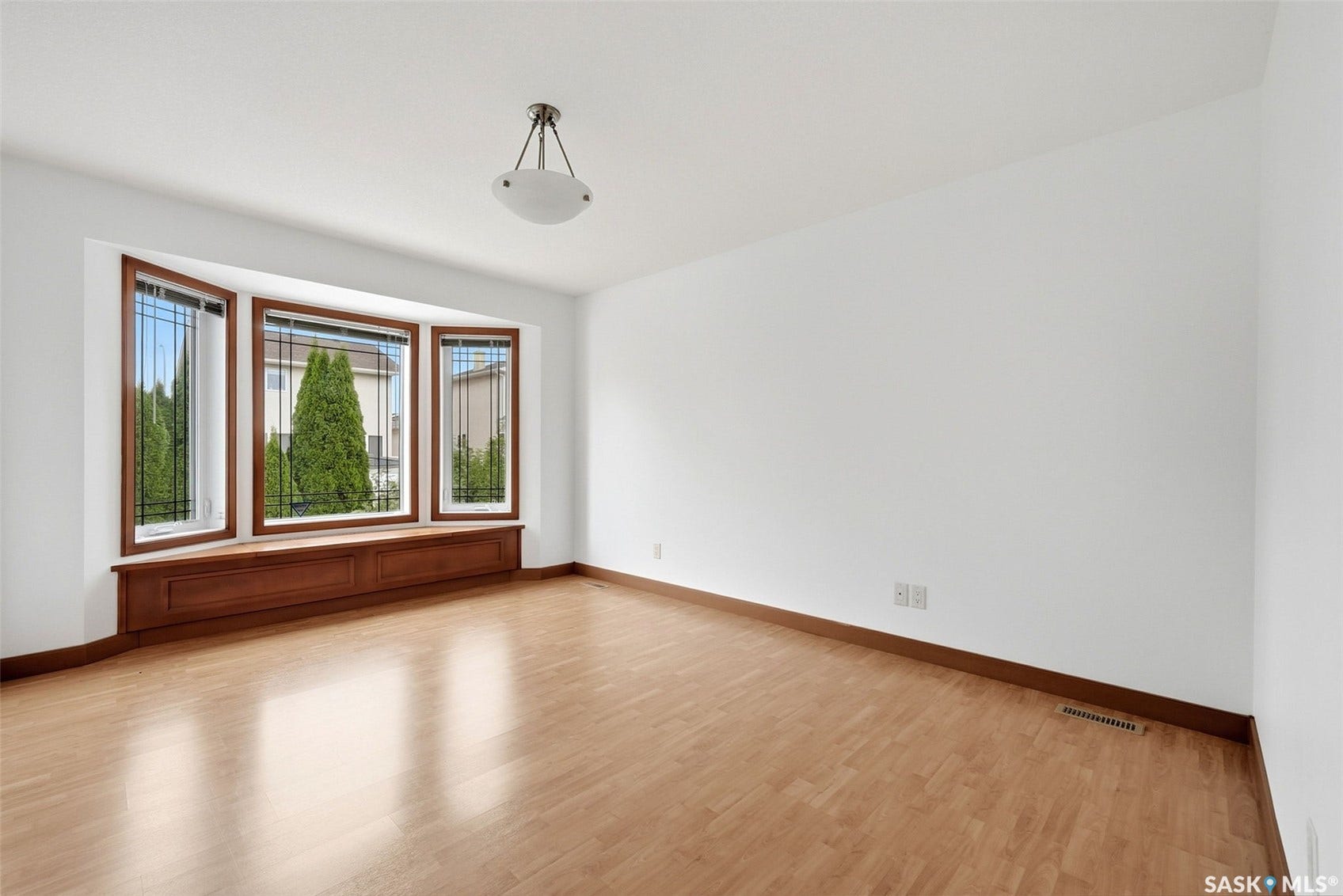Bay window with wood-finish trim and integrated storage bench