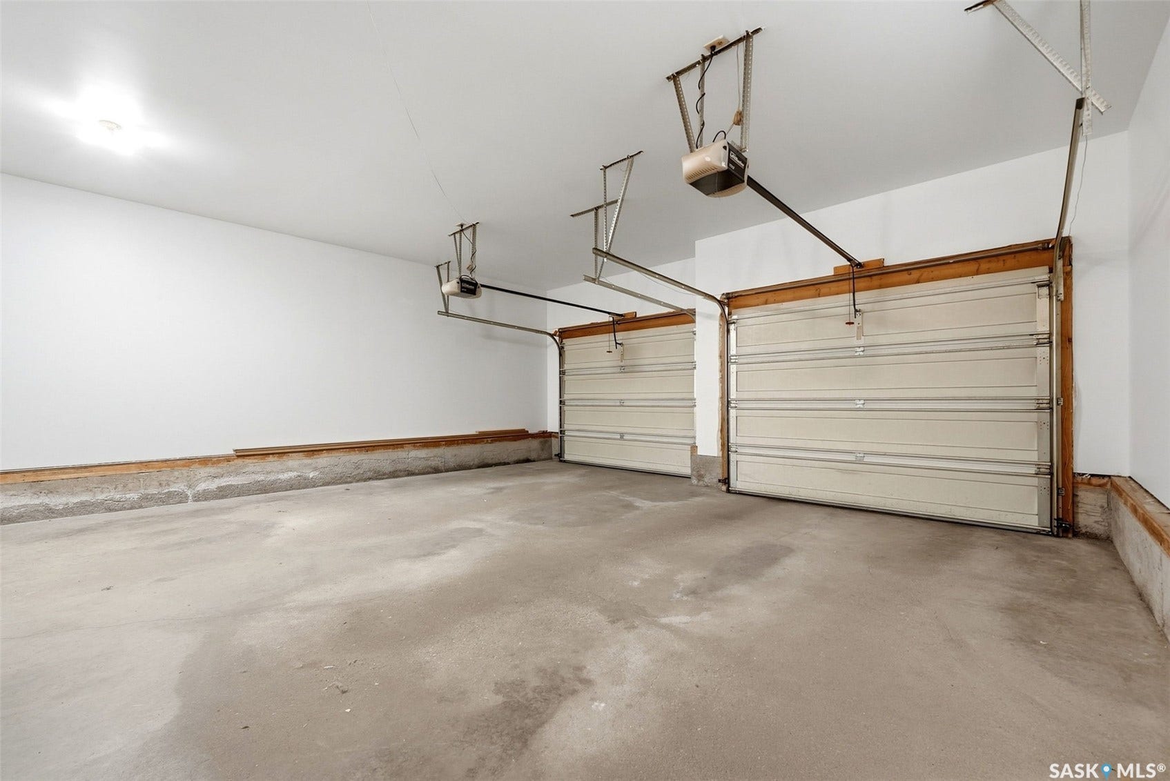 Two-car garage with concrete flooring and overhead lighting