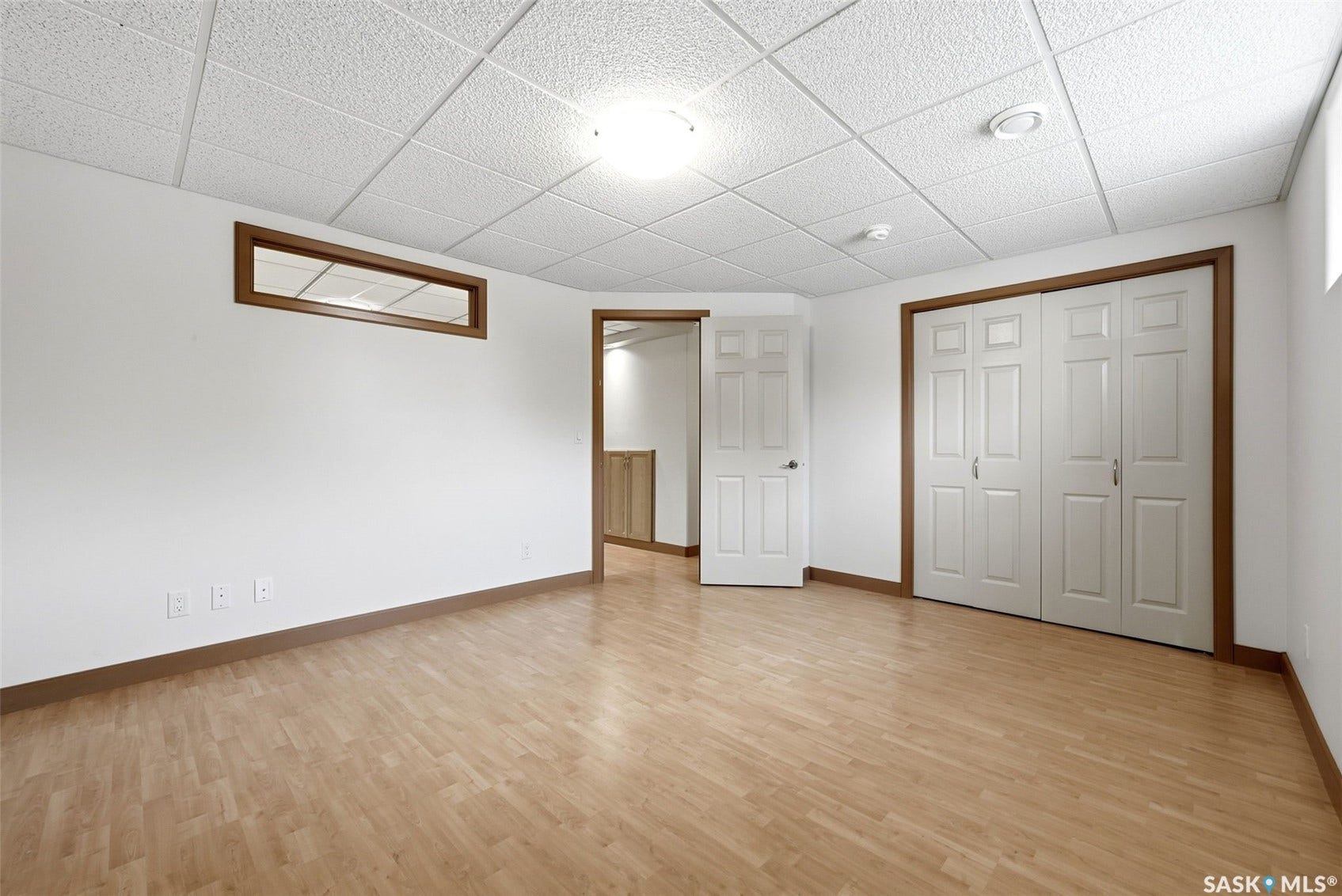 Wood-finish flooring with white walls and contrasting wood trim