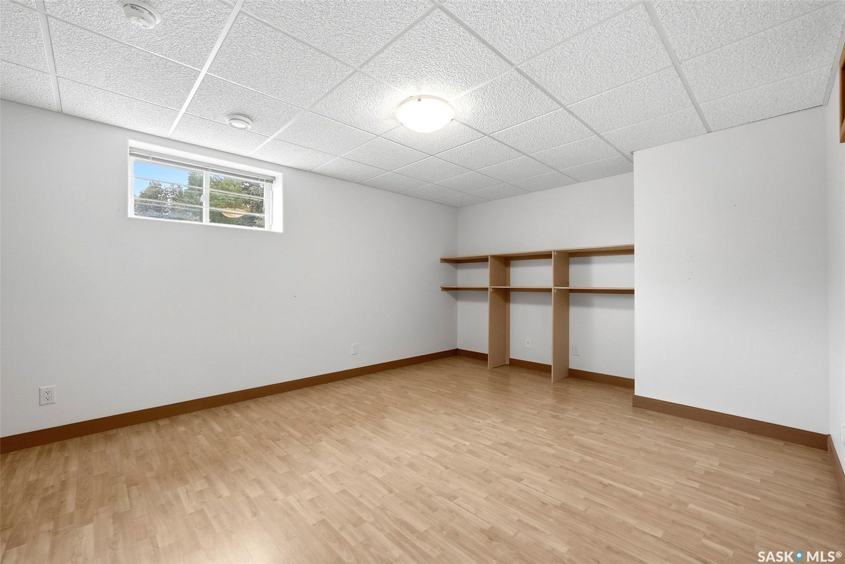 Recessed window, wood-finish flooring, built-in shelving, drop ceiling, flush mount lighting