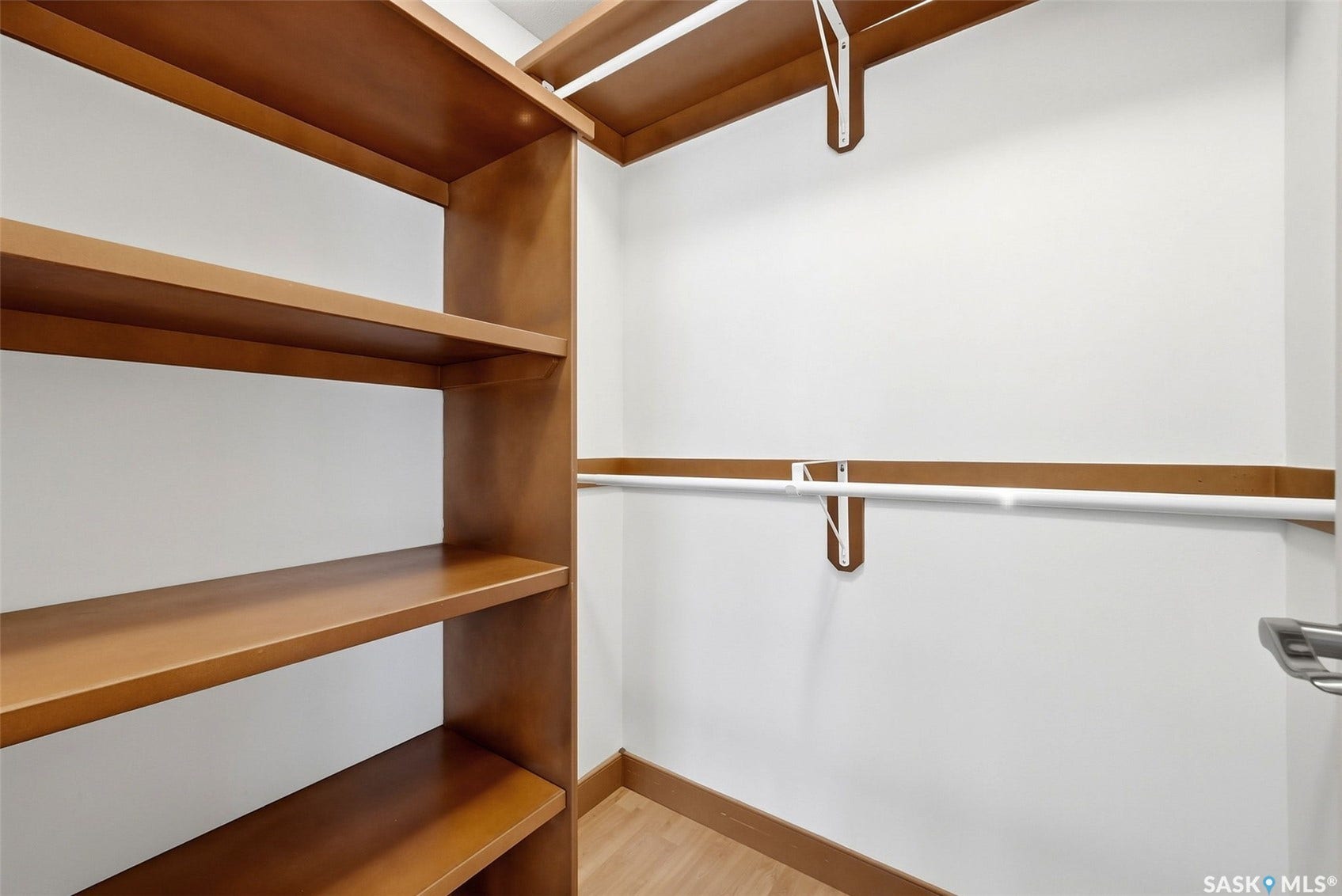 Built-in wood-finish shelving and hanging rods
