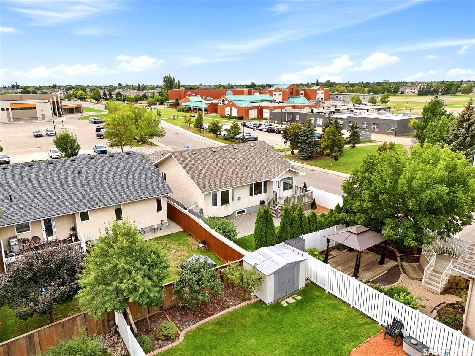 Expansive backyard featuring a gazebo, tiered deck, storage shed, and manicured lawn
