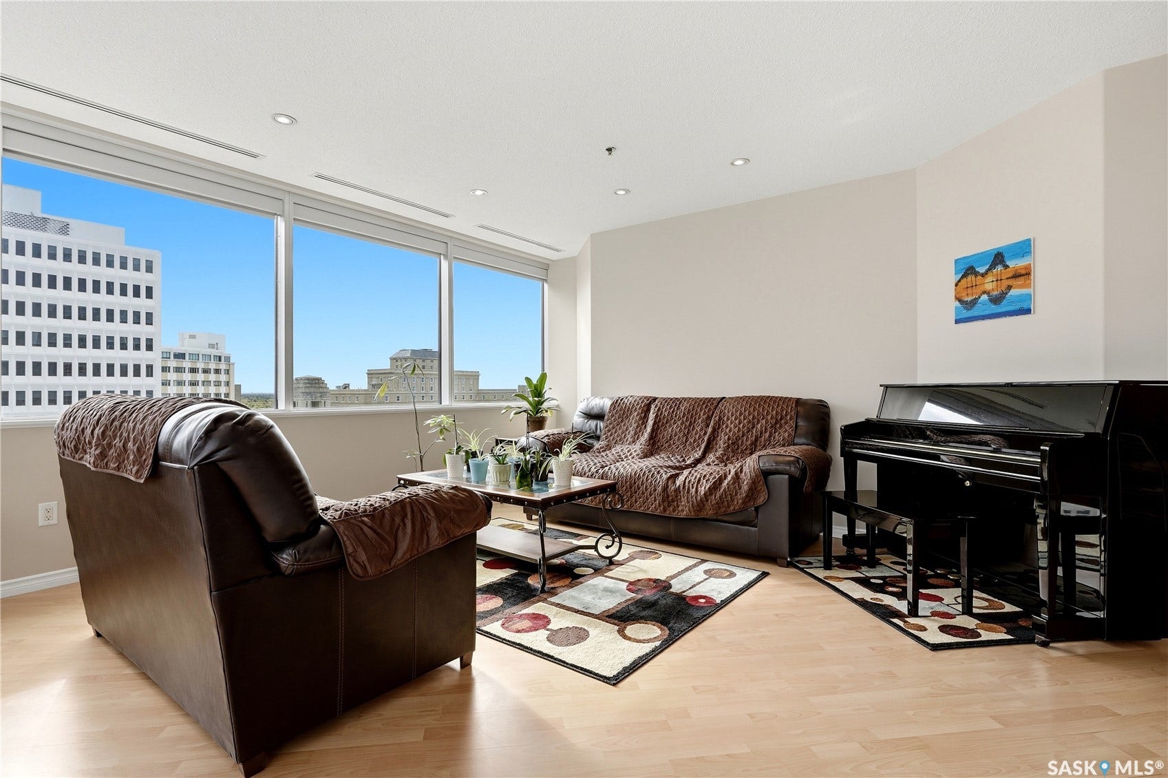 1914 Hamilton Street, #1007, Regina SK S4P 3N6 Expansive window wall with multiple panes, recessed ceiling lighting, light wood-finish flooring, and neutral wall tones