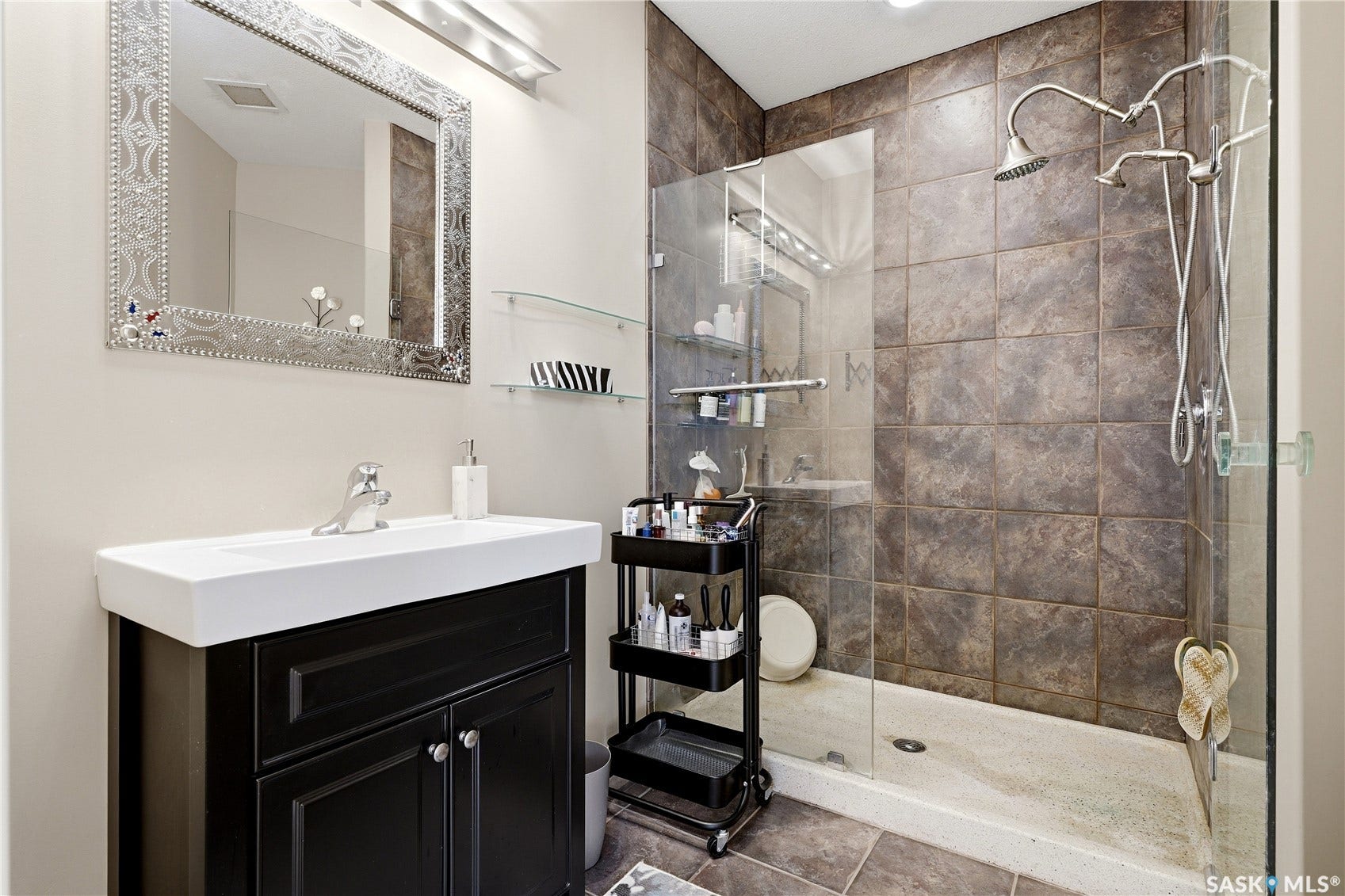 1914 Hamilton Street, #1007, Regina SK S4P 3N6 Modern vanity with a rectangular basin sink, dark wood-finish cabinetry, and chrome fixtures