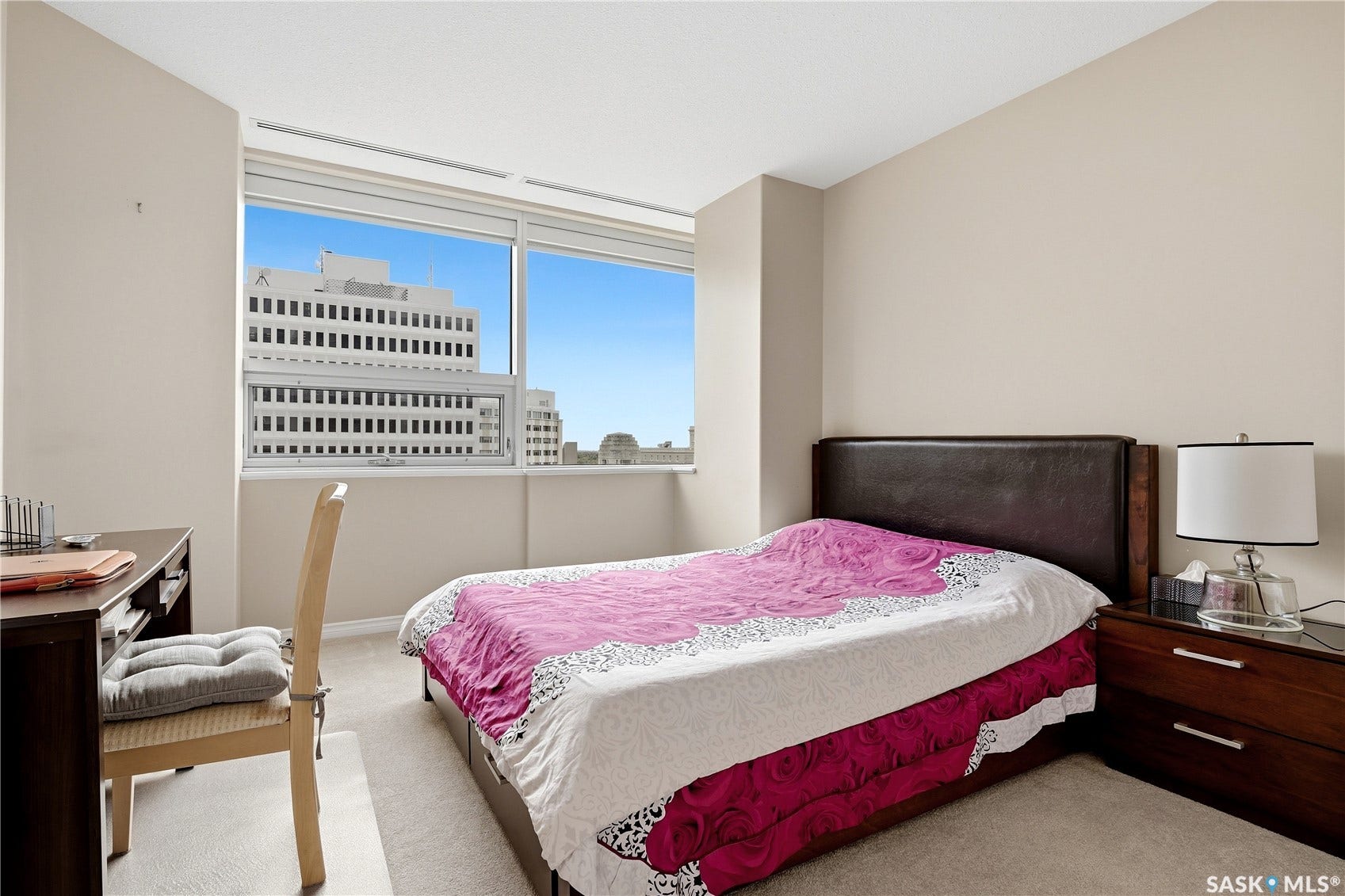 1914 Hamilton Street, #1007, Regina SK S4P 3N6 Expansive window offering urban scenery, neutral wall tones, and carpeted flooring