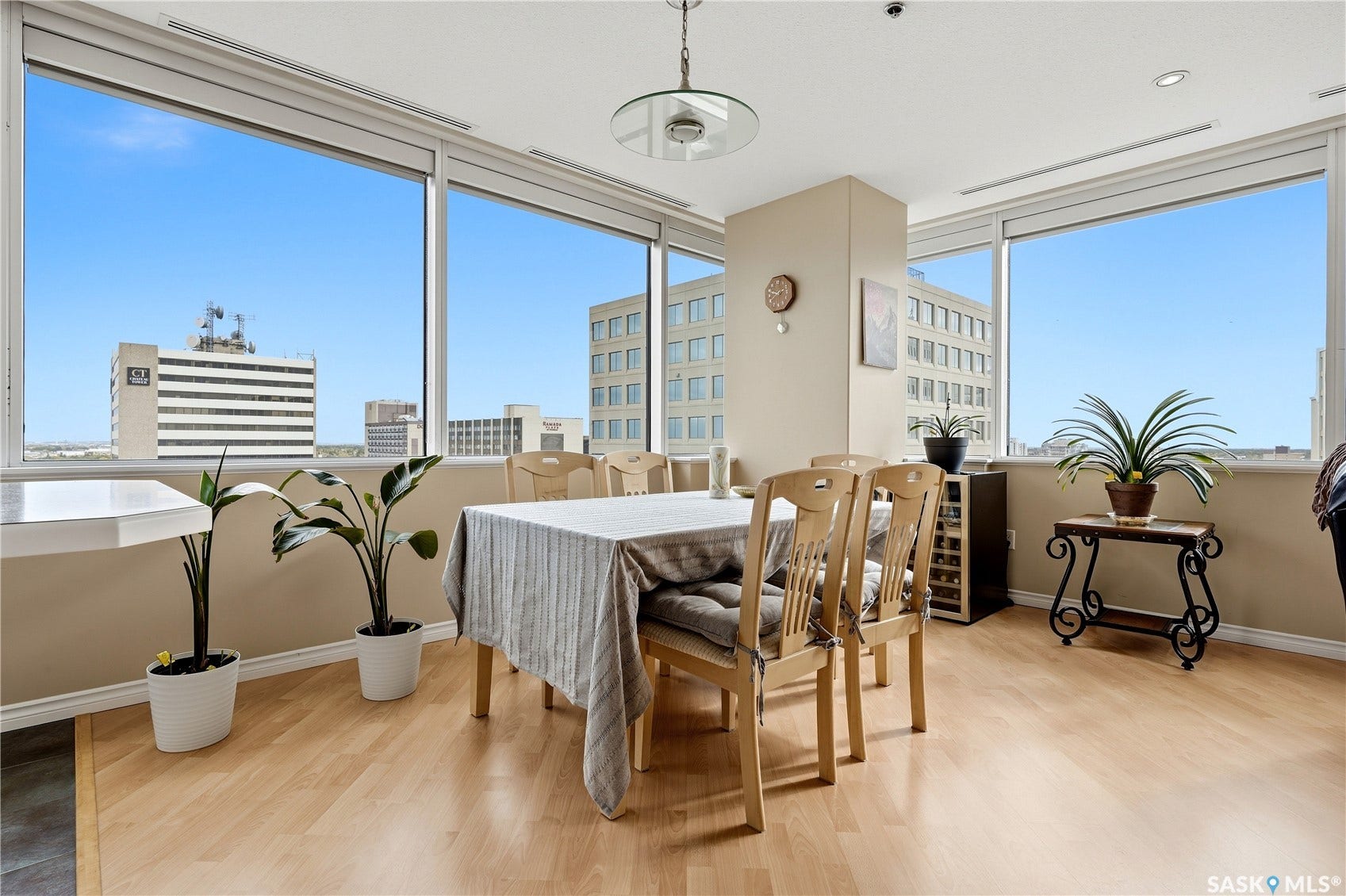 1914 Hamilton Street, #1007, Regina SK S4P 3N6 Expansive window banks, light wood-finish flooring, recessed lighting, neutral wall tones, and a suspended ceiling fixture