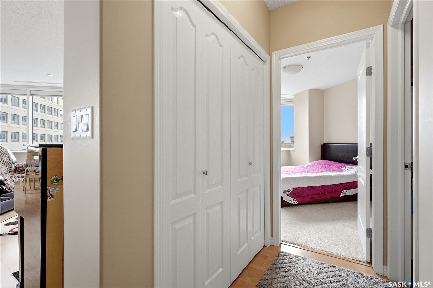 1914 Hamilton Street, #1007, Regina SK S4P 3N6 Hardwood-finish flooring, white bifold closet doors, and light neutral wall colors