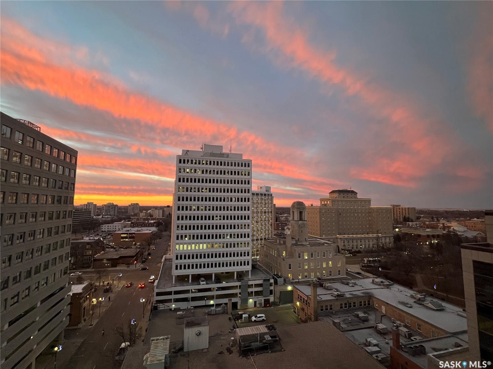 1914 Hamilton Street, #1007, Regina SK S4P 3N6 Cityscape featuring multiple commercial buildings, a structured parking garage, and a multi-lane street