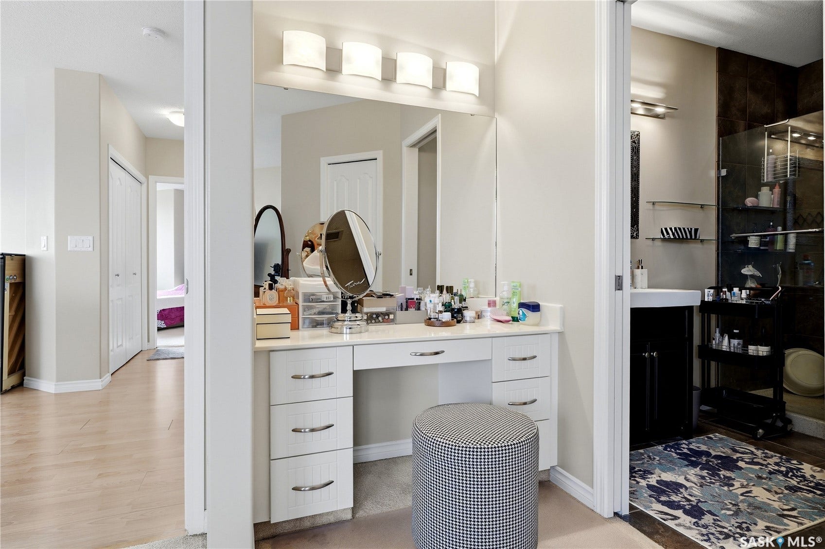 1914 Hamilton Street, #1007, Regina SK S4P 3N6 Vanity with built-in storage drawers, a large integrated mirror, and overhead lighting