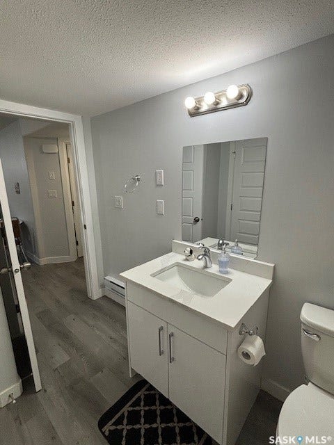 White vanity with a single basin sink, chrome faucet, and integrated countertop
