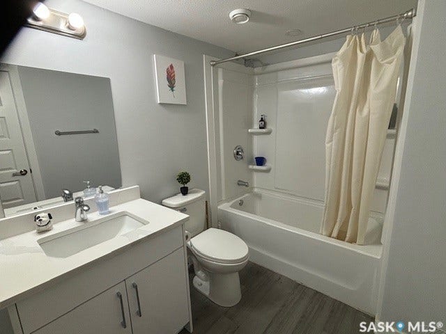 White vanity with integrated sink, chrome faucet, and storage cabinetry