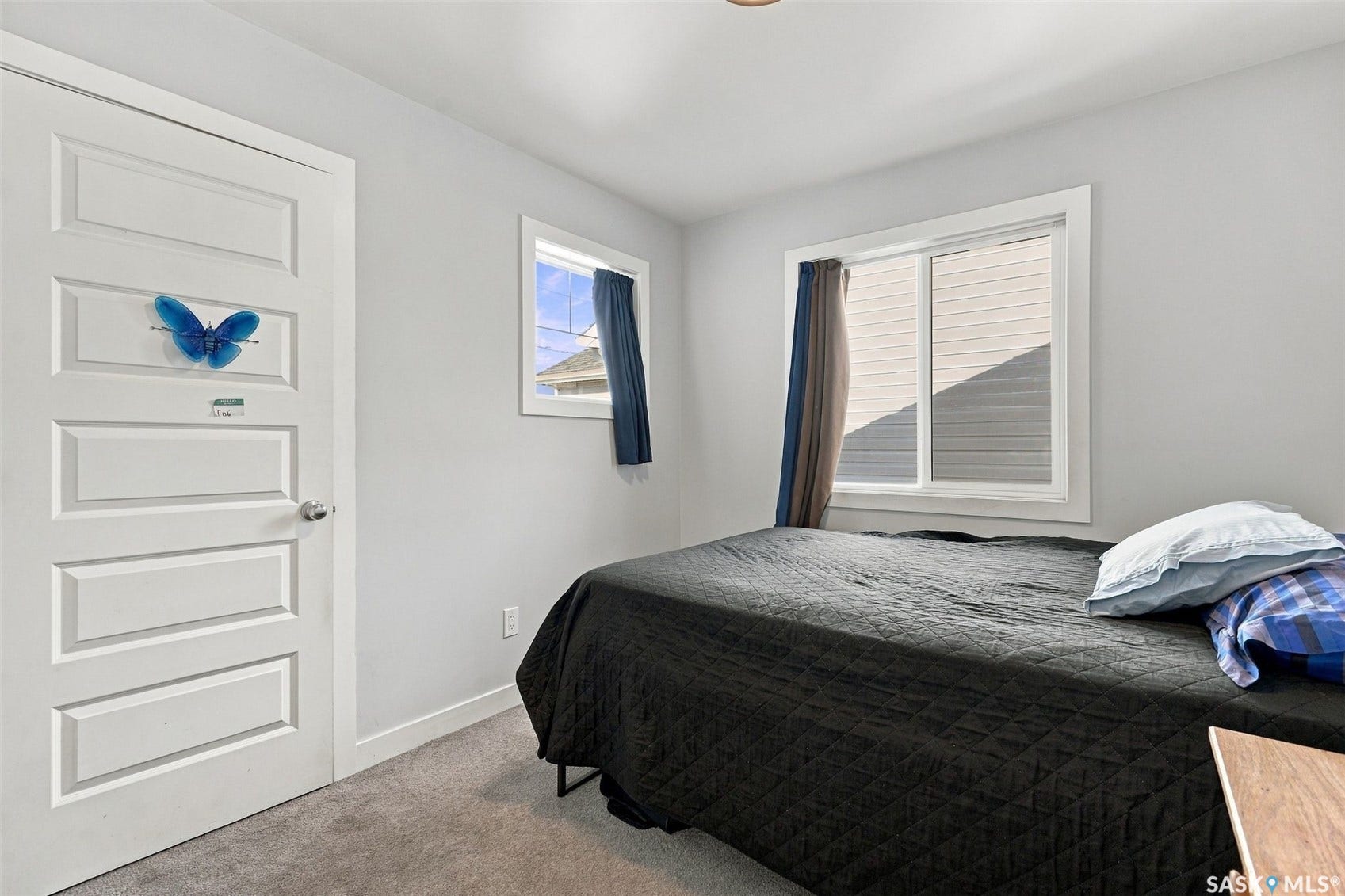 Recessed lighting, light gray wall paint, white trim, gray carpet flooring, and white paneled door