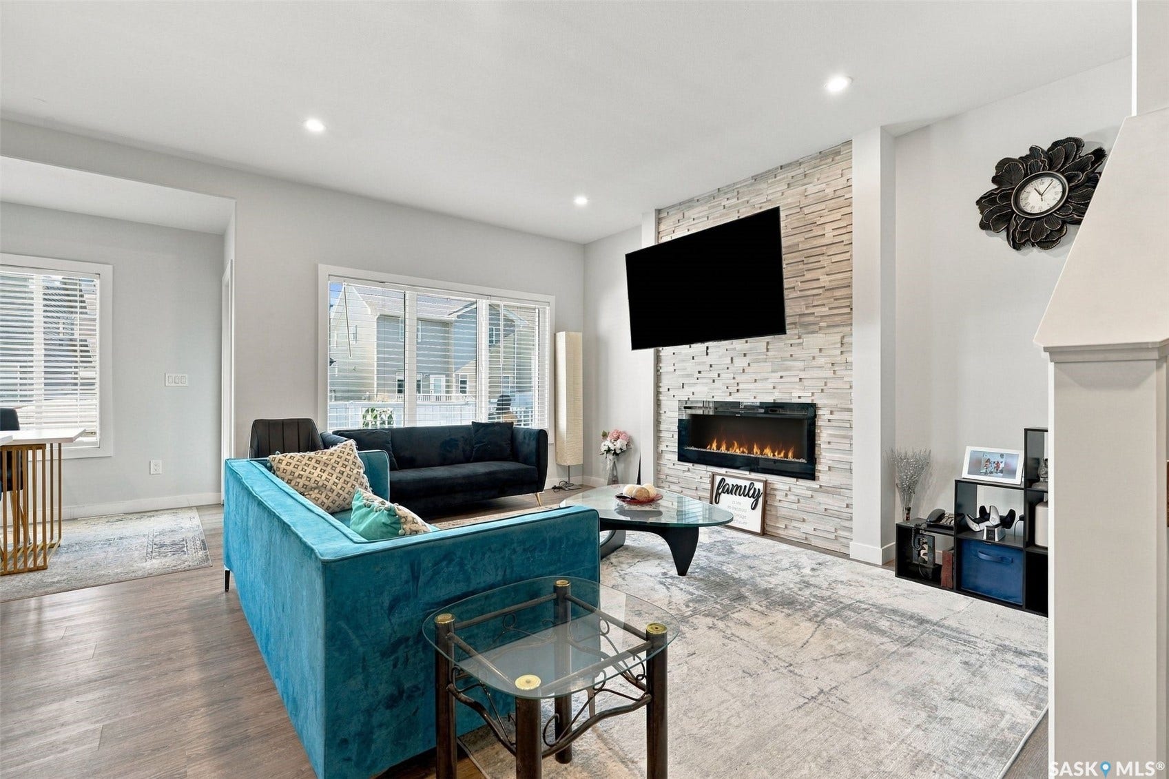 Recessed lighting illuminates wood-finish flooring