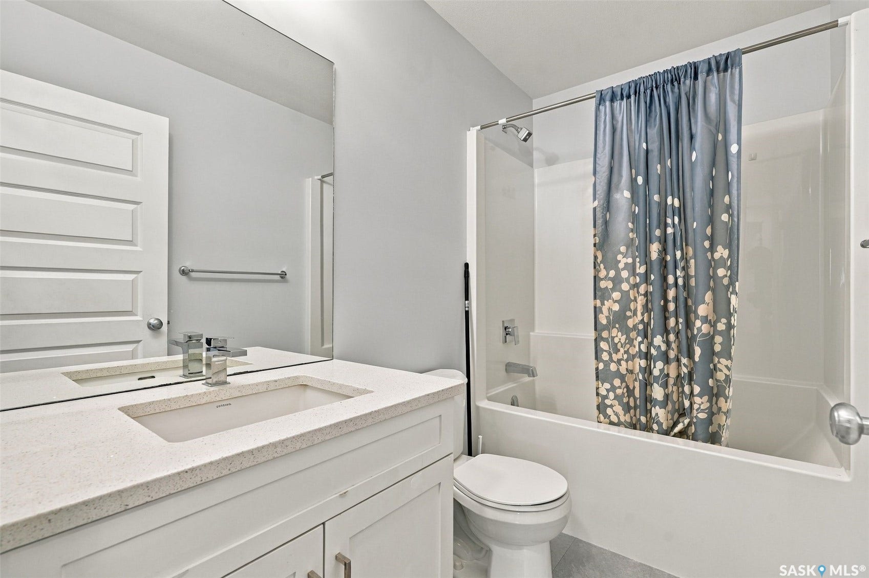 Contemporary vanity with an integrated sink and quartz-finish countertop