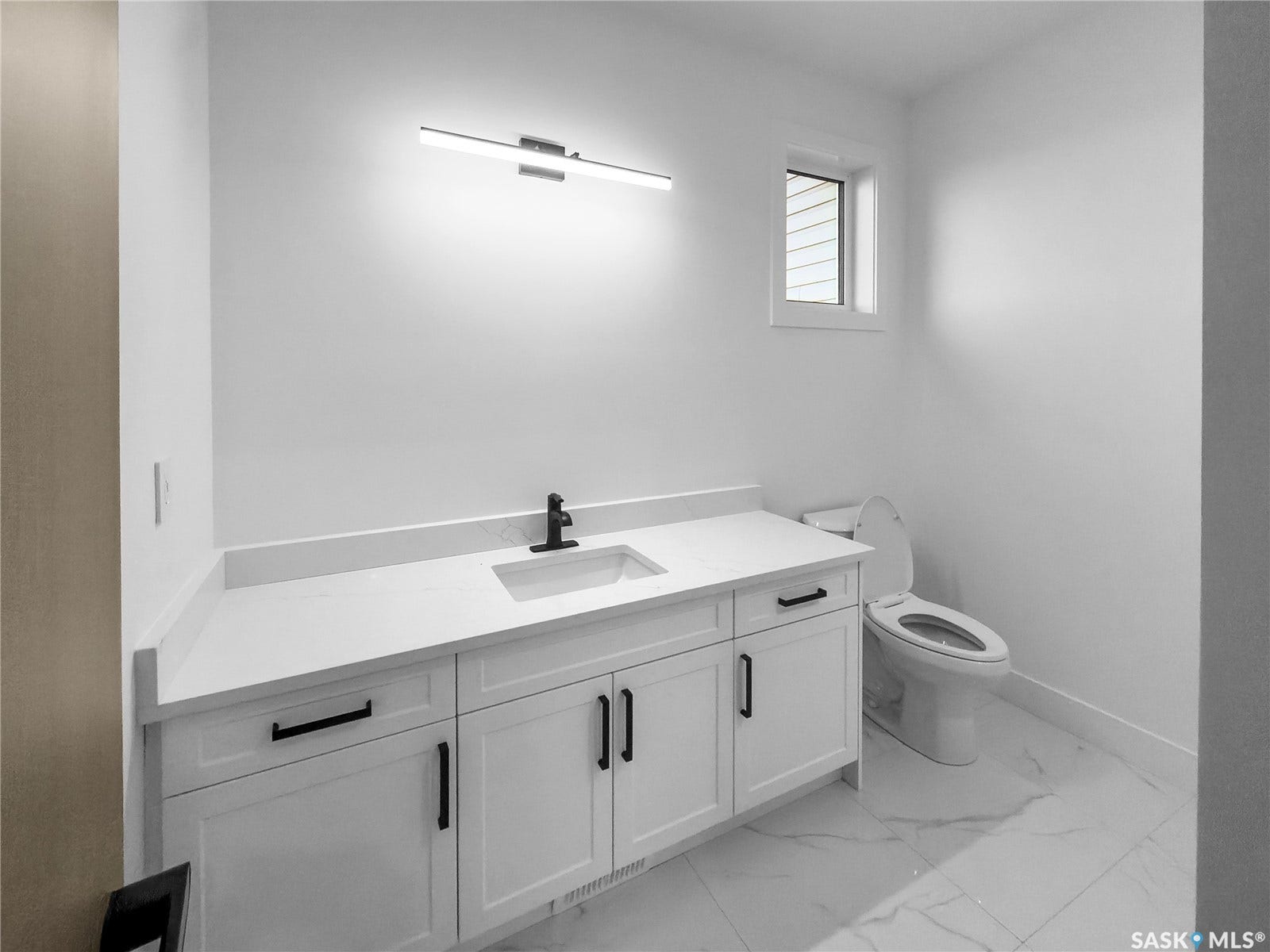 12 Elkwood Cove, Dundurn Rm No SK S7C 0C5 White vanity with matte black hardware, single sink, and white countertop