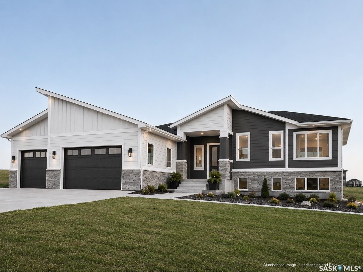 12 Elkwood Cove, Dundurn Rm No SK S7C 0C5 Contemporary exterior featuring white vertical siding and dark horizontal siding, stone veneer accents, a prominent two-car garage, and a covered entry porch