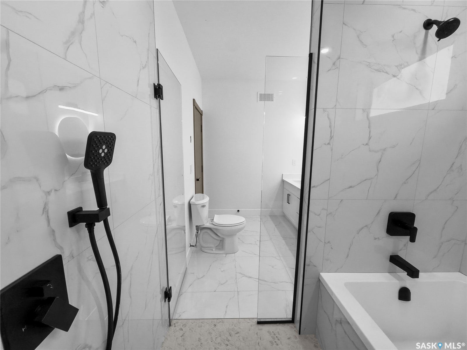 12 Elkwood Cove, Dundurn Rm No SK S7C 0C5 Glass-enclosed shower with matte black fixtures, white marble-patterned tile, and a built-in bathtub