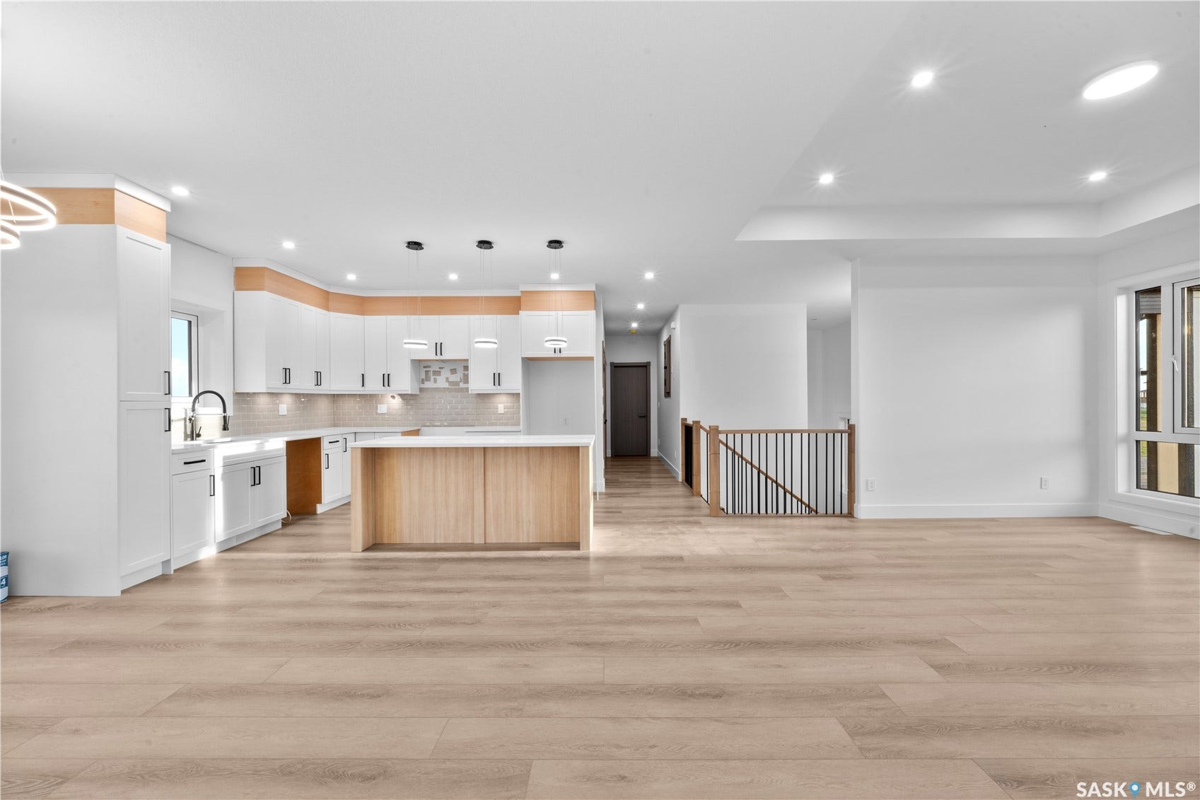 12 Elkwood Cove, Dundurn Rm No SK S7C 0C5 Spacious open-concept living area featuring light wood-finish flooring