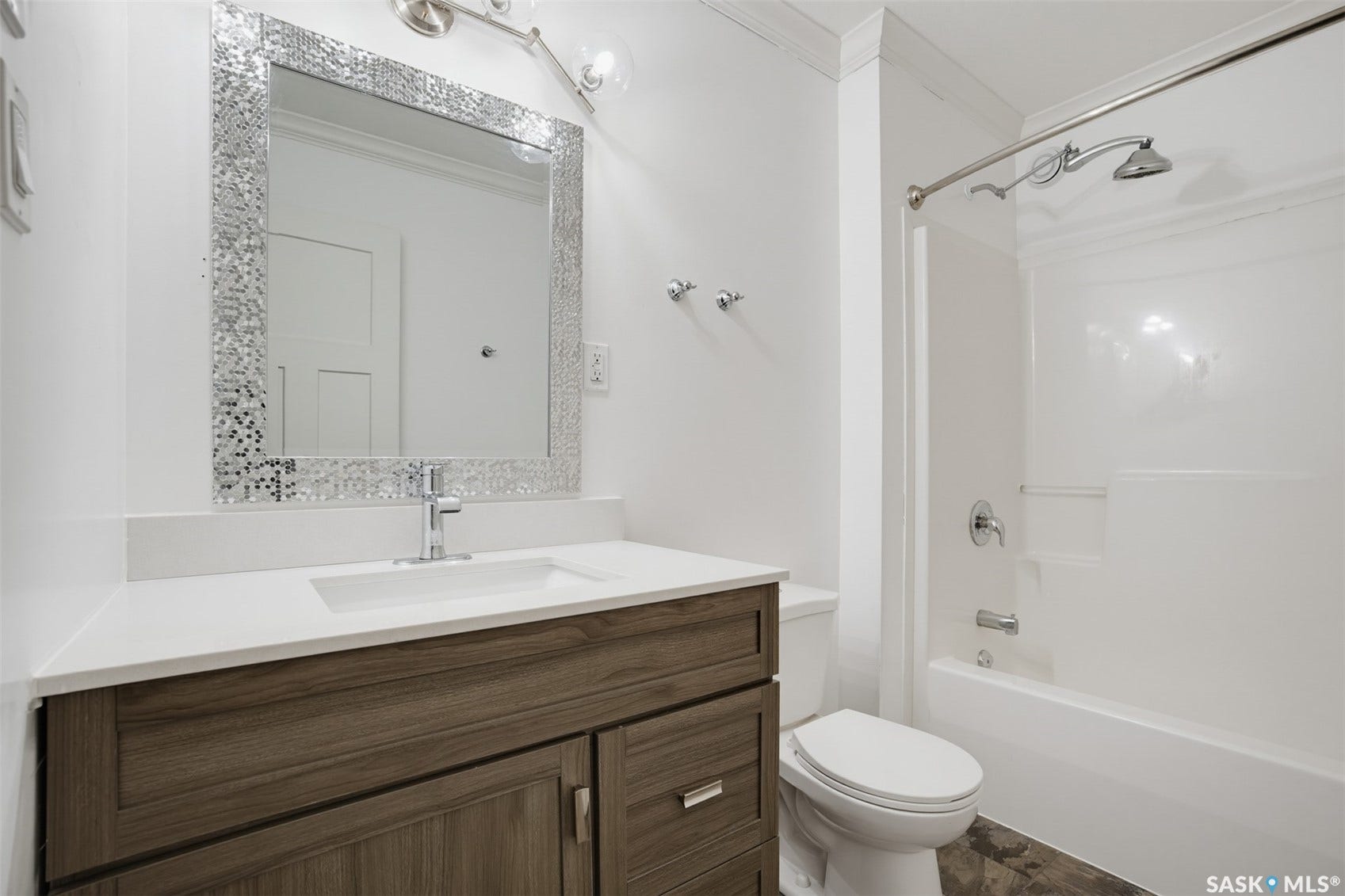 Wood-finish vanity with integrated sink, chrome faucet, and quartz countertop
