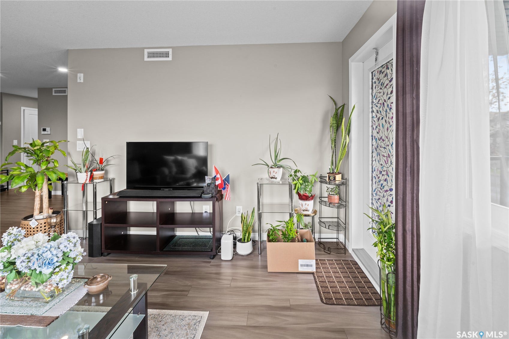 Recessed ceiling lighting, wood-finish flooring, and a decorative frosted glass entry door