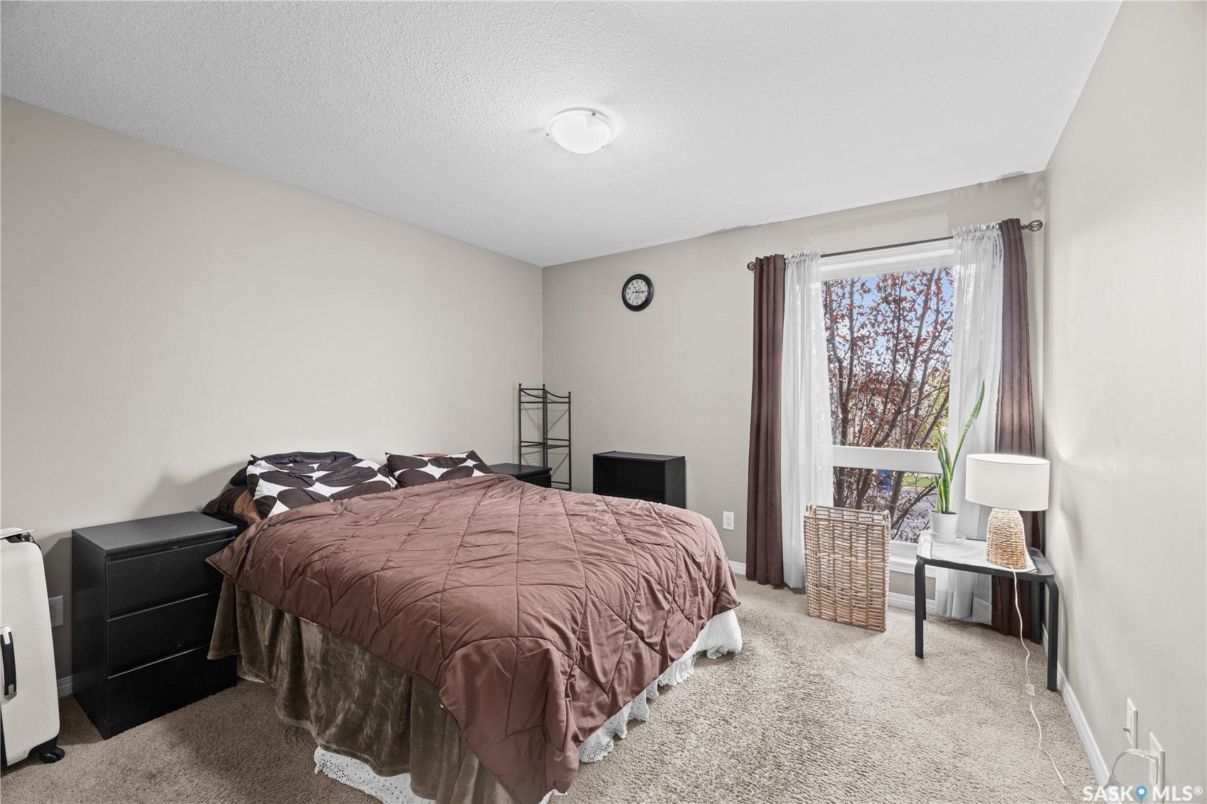 Carpeted flooring, recessed lighting, and a large window with privacy coverings