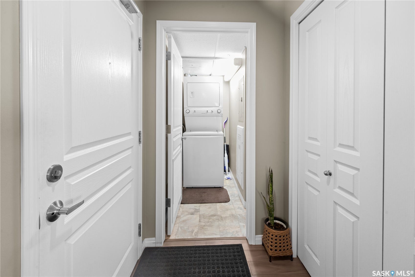 Hallway featuring light wood-finish flooring, neutral wall paint, and white paneled doors