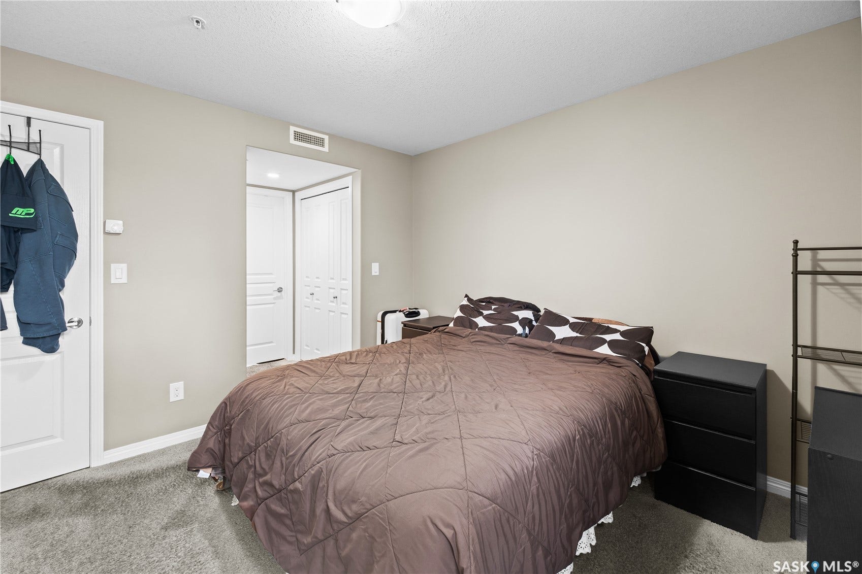 Neutral wall color, wall-to-wall carpeting, white interior doors, and a ceiling-mounted light fixture