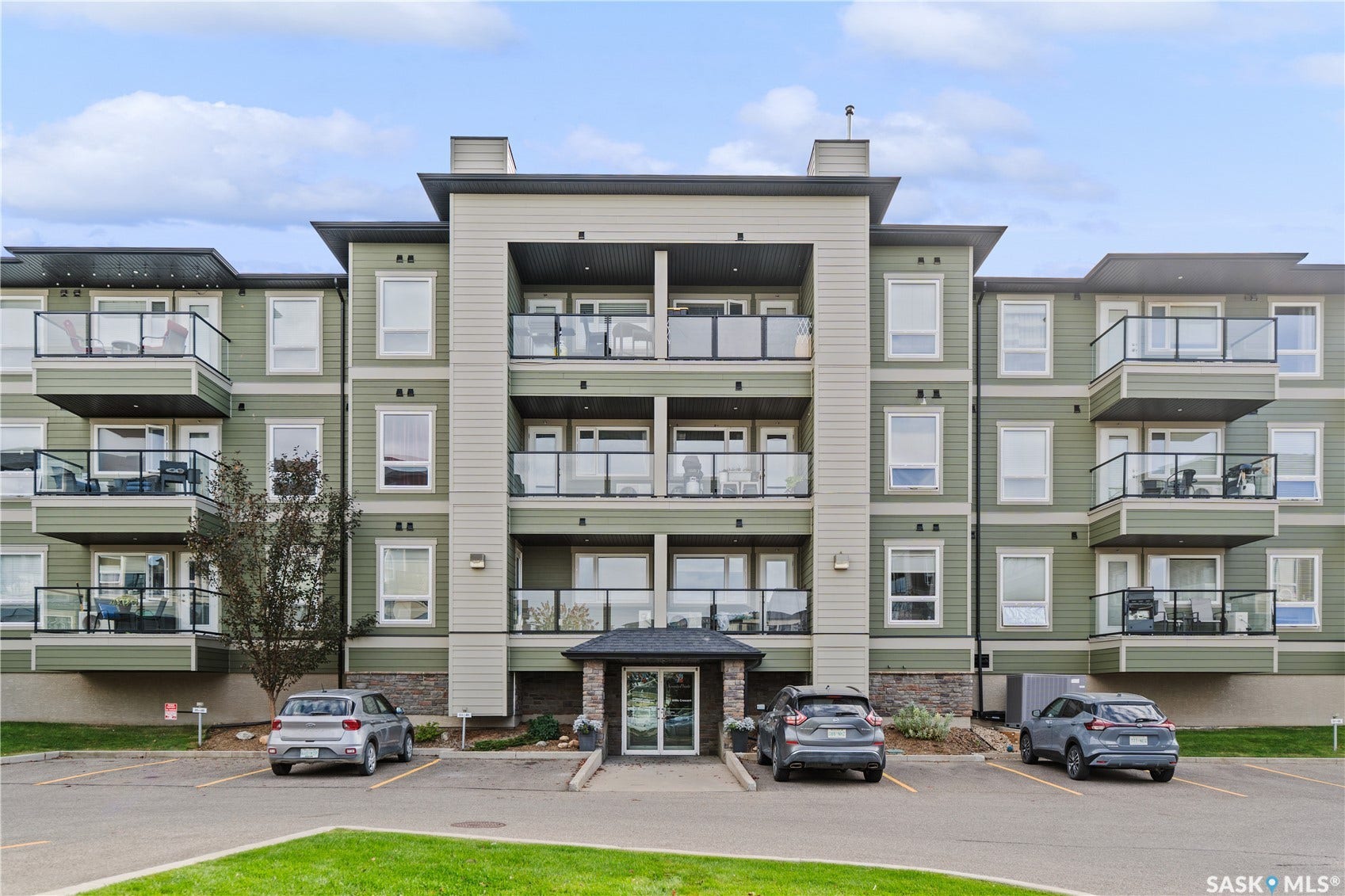 Modern condominium building featuring multiple private balconies with glass railings