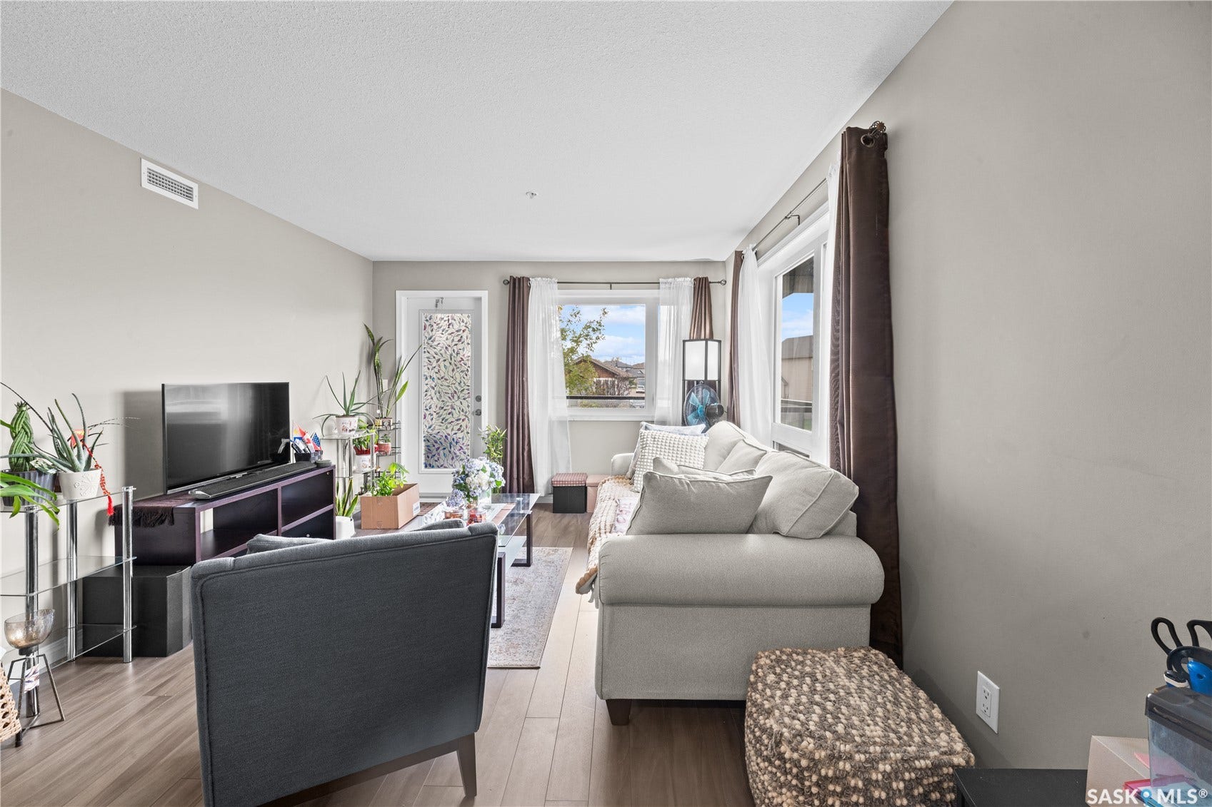 Wood-finish flooring, light-colored walls, white trim, and a glass-paneled door