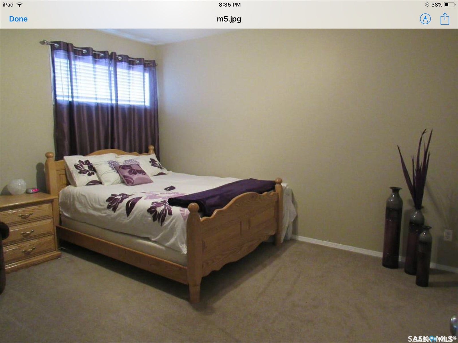 Recessed window with horizontal blinds and full-length drapes