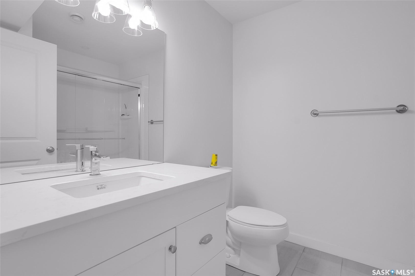 White vanity with integrated rectangular sink and chrome faucet