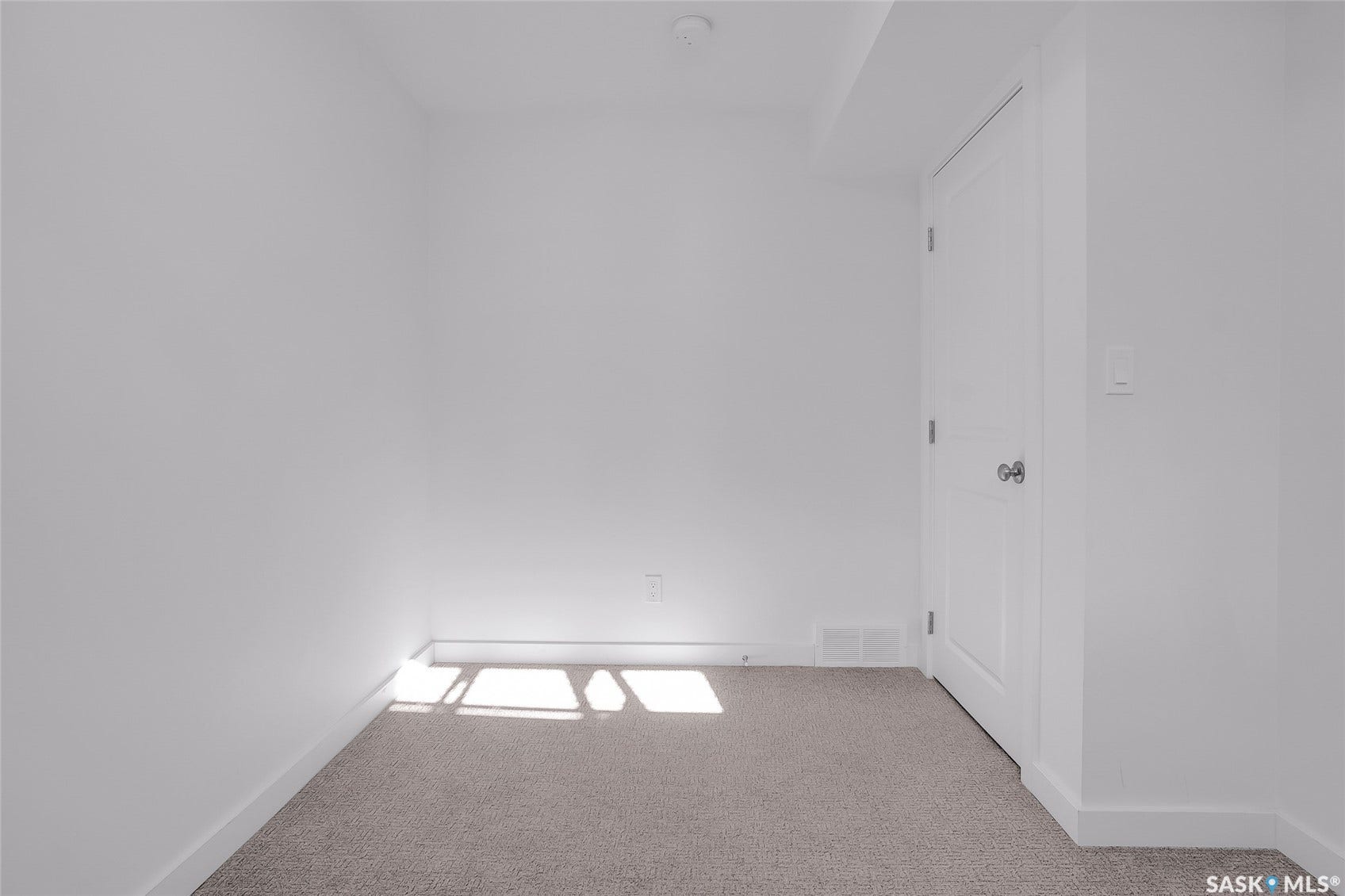 Neutral-toned carpeting paired with crisp white walls