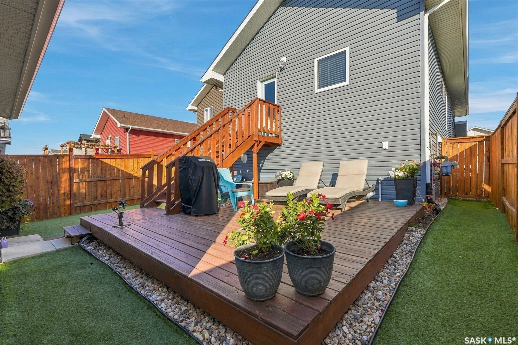 919 Kolynchuk Bend, Saskatoon SK S7T 0V9 Expansive wooden deck with stairs and a privacy fence