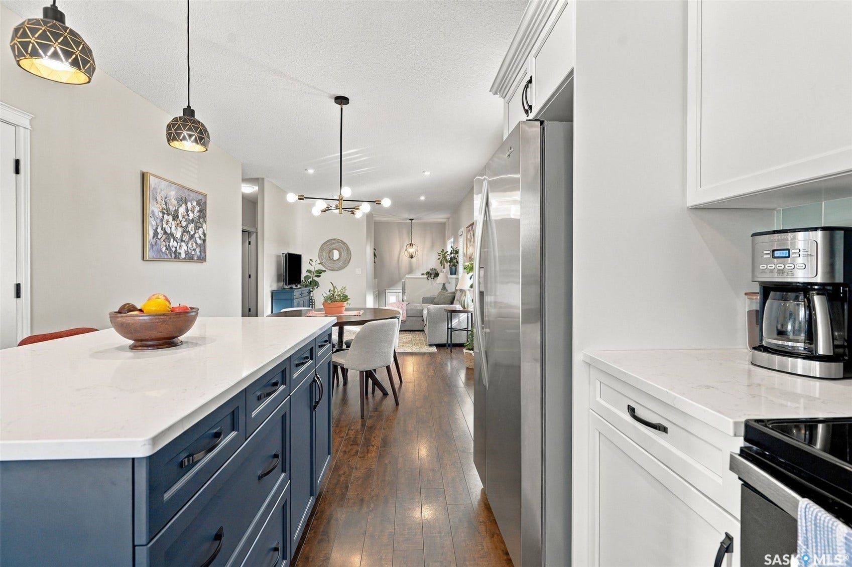 919 Kolynchuk Bend, Saskatoon SK S7T 0V9 Wood-finish flooring, recessed lighting, and a kitchen island with a light-toned countertop