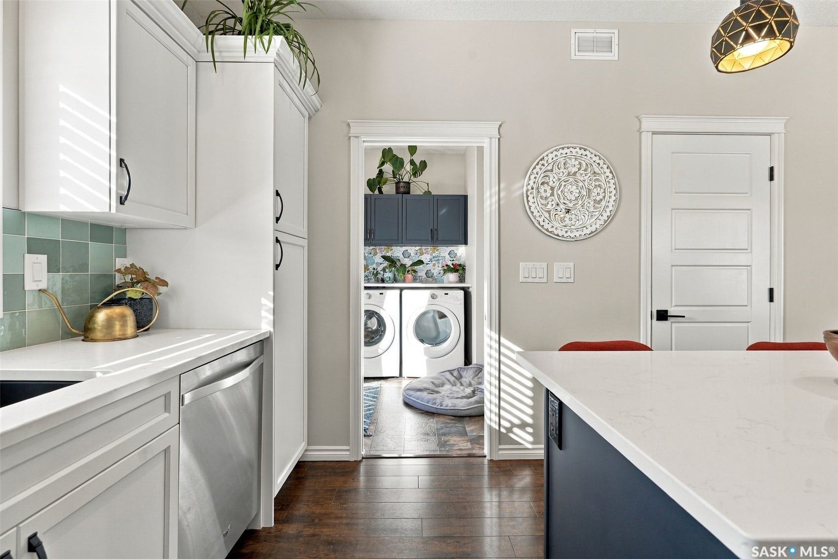919 Kolynchuk Bend, Saskatoon SK S7T 0V9 White cabinetry with dark hardware, stainless steel dishwasher, and light-toned countertop
