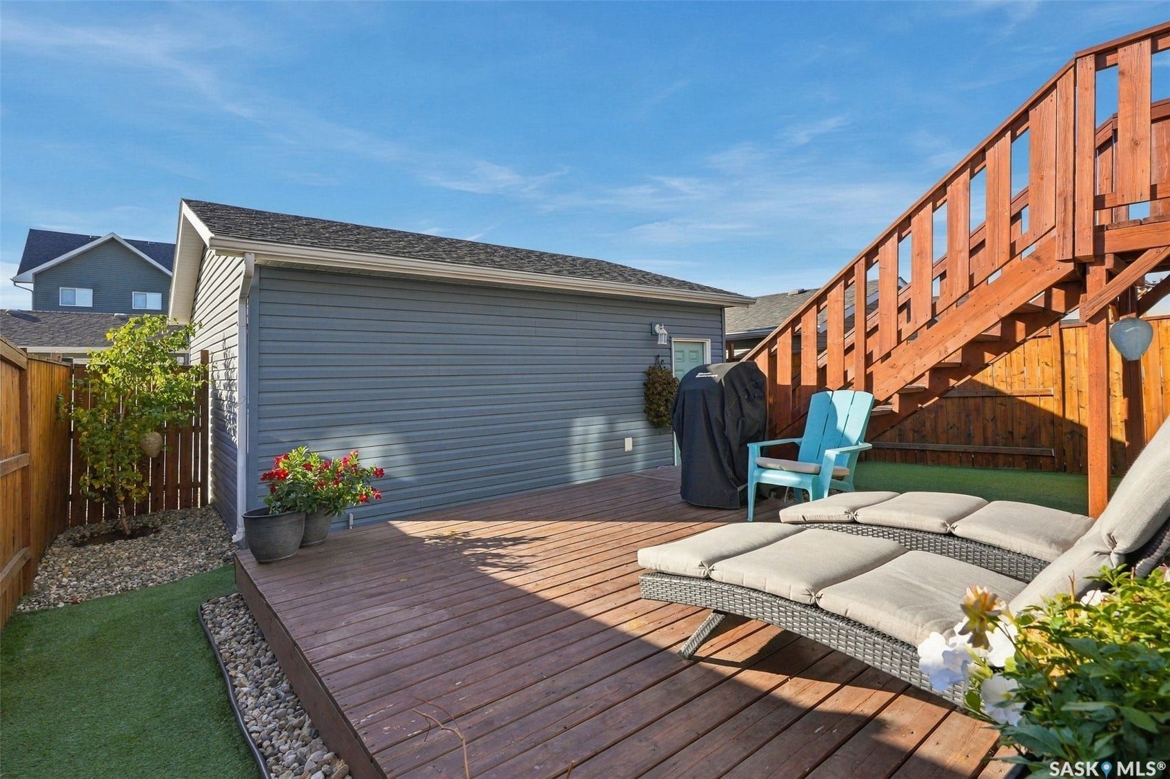 919 Kolynchuk Bend, Saskatoon SK S7T 0V9 Wood-finish deck with a built-in privacy fence and artificial turf