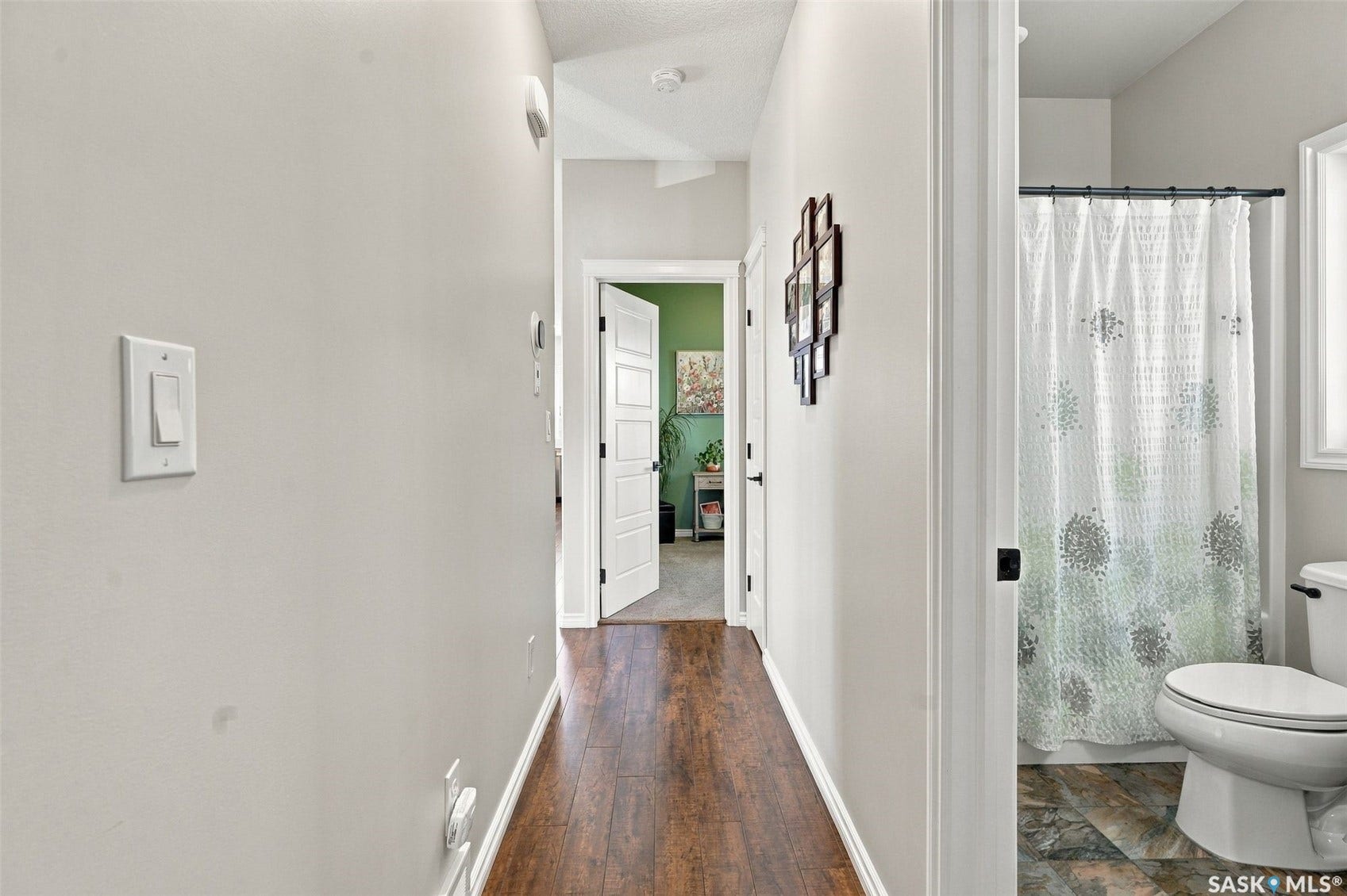 919 Kolynchuk Bend, Saskatoon SK S7T 0V9 Hallway with wood-finish flooring and light wall paint
