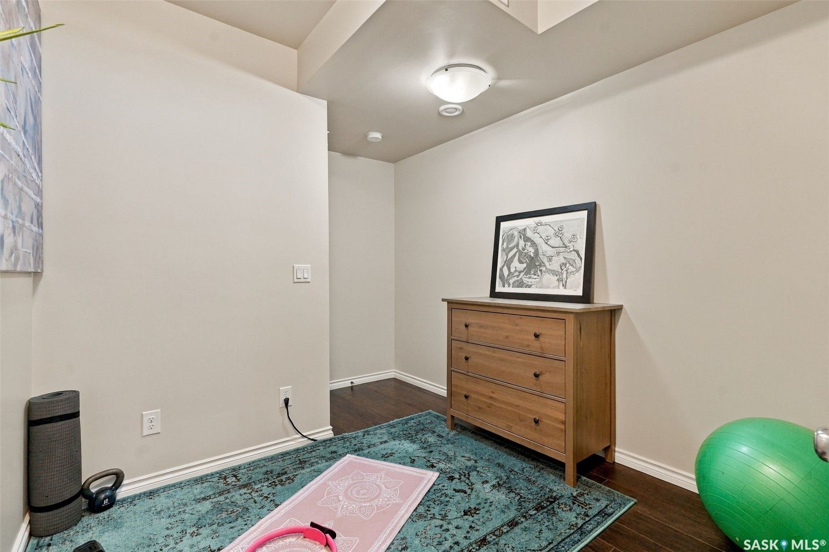 919 Kolynchuk Bend, Saskatoon SK S7T 0V9 Dark wood-finish flooring with light wall paint and white trim molding