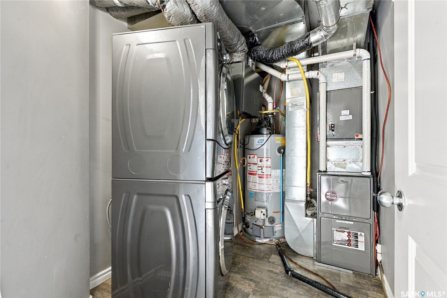 Stackable laundry appliances, water heater, and HVAC system
