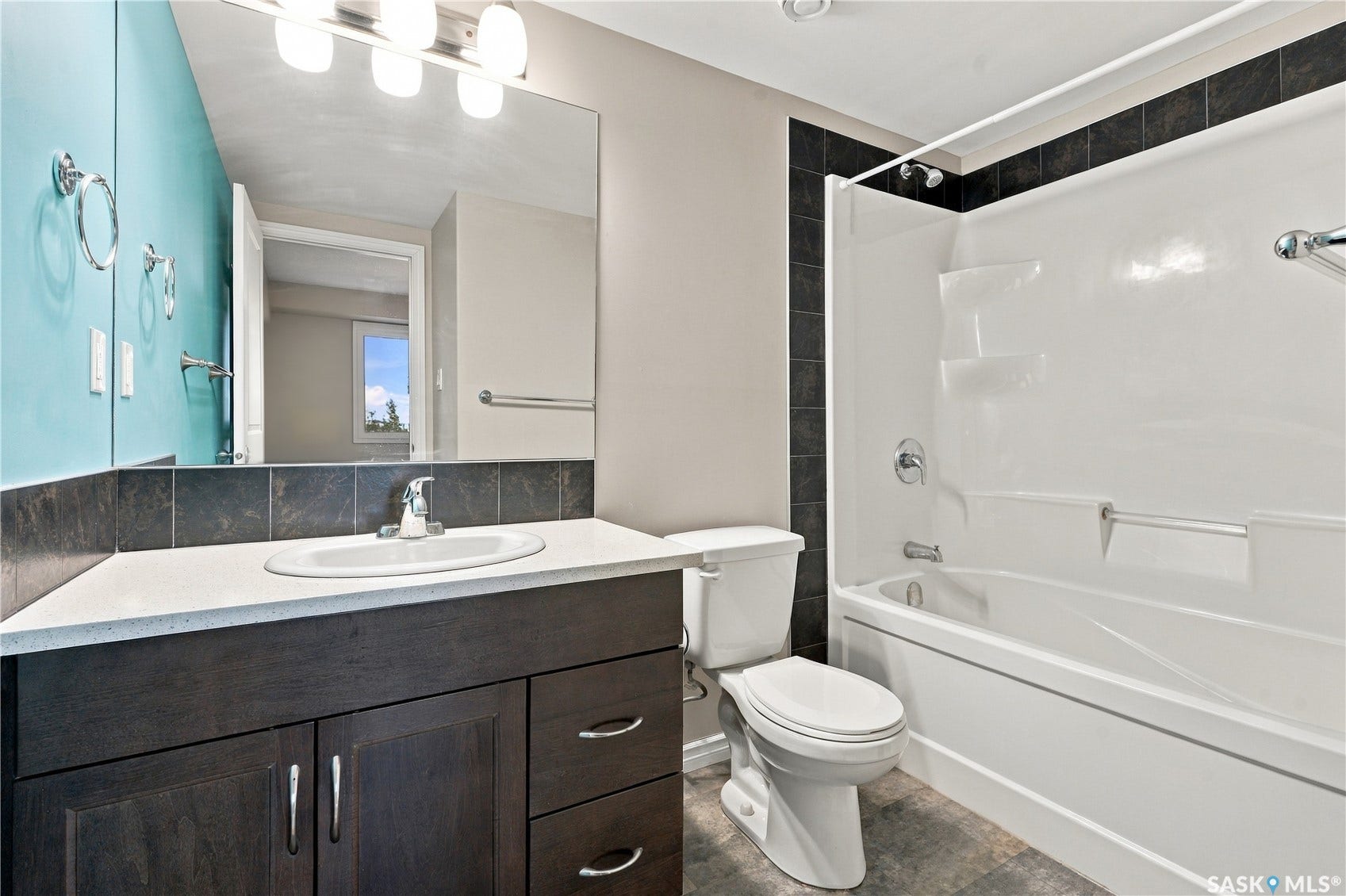 4 piece ensuite with dark wood vanity, quartz countertop