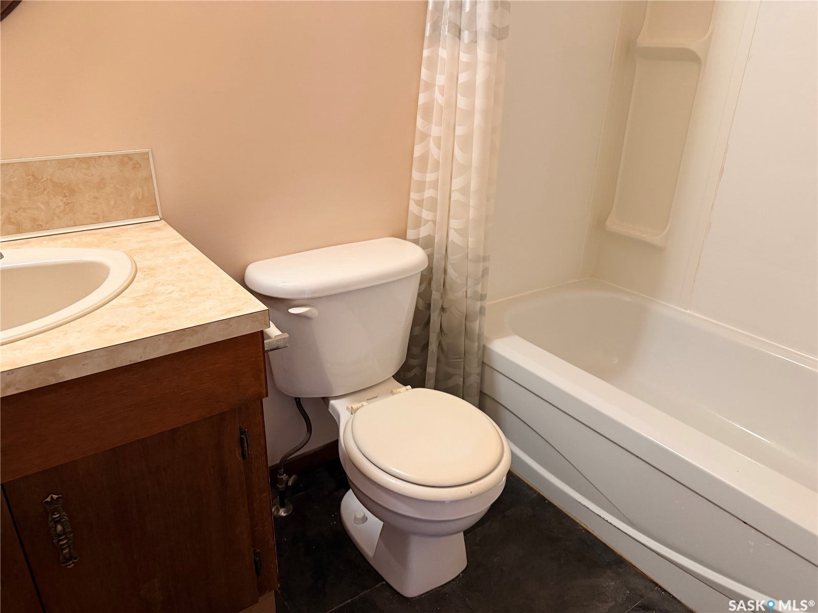 Wood-finish vanity with an integrated sink and laminate countertop