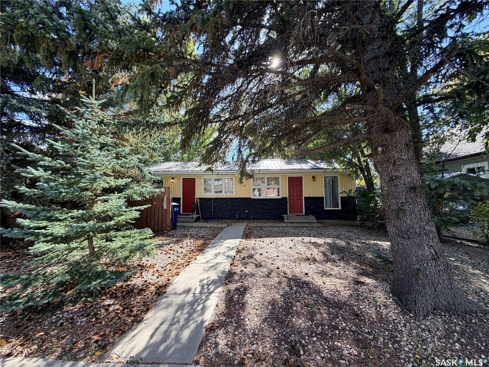 Ranch-style exterior with yellow siding and a dark gray lower facade