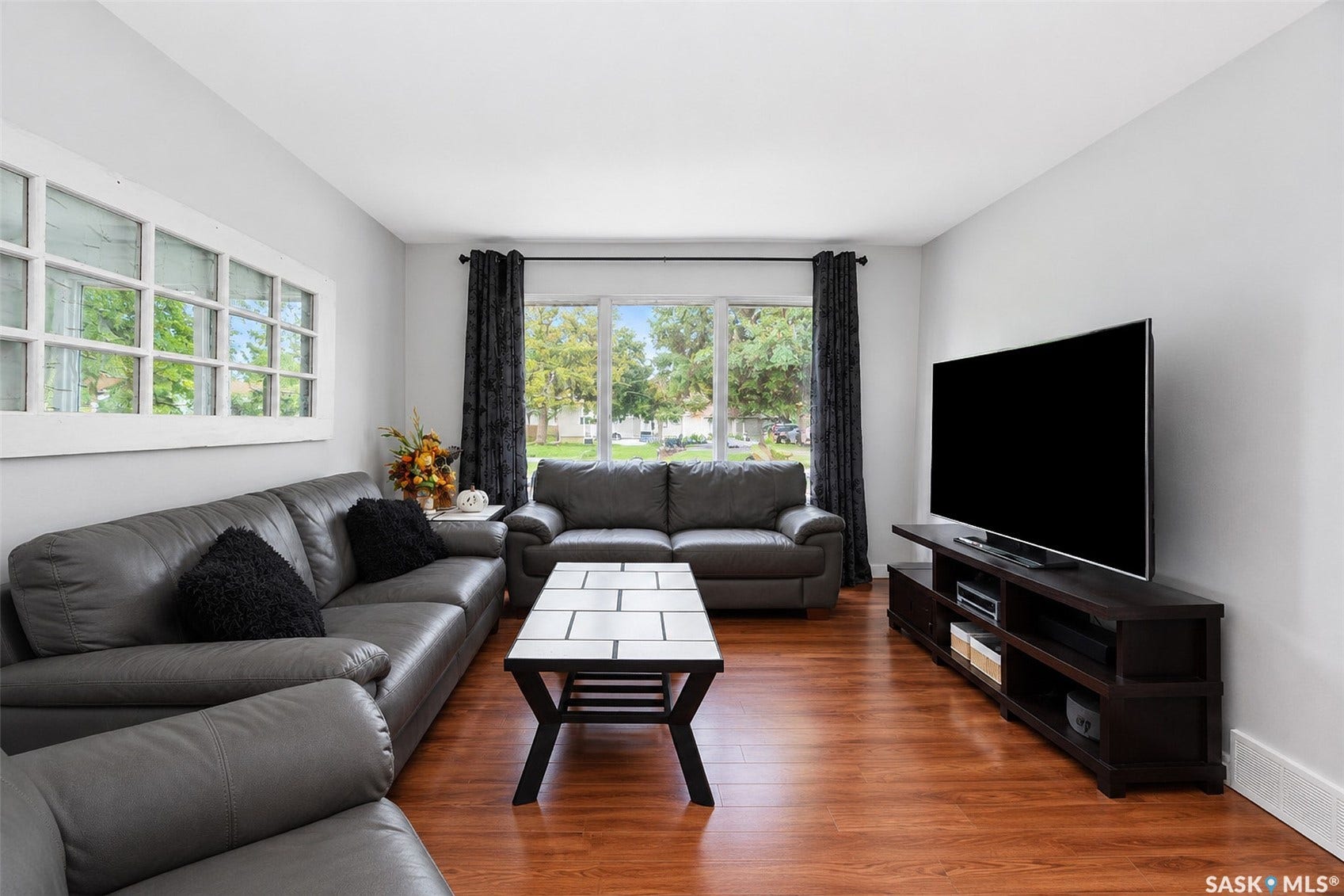 Wood-finish flooring, large windows, recessed ceiling, and a clean wall finish