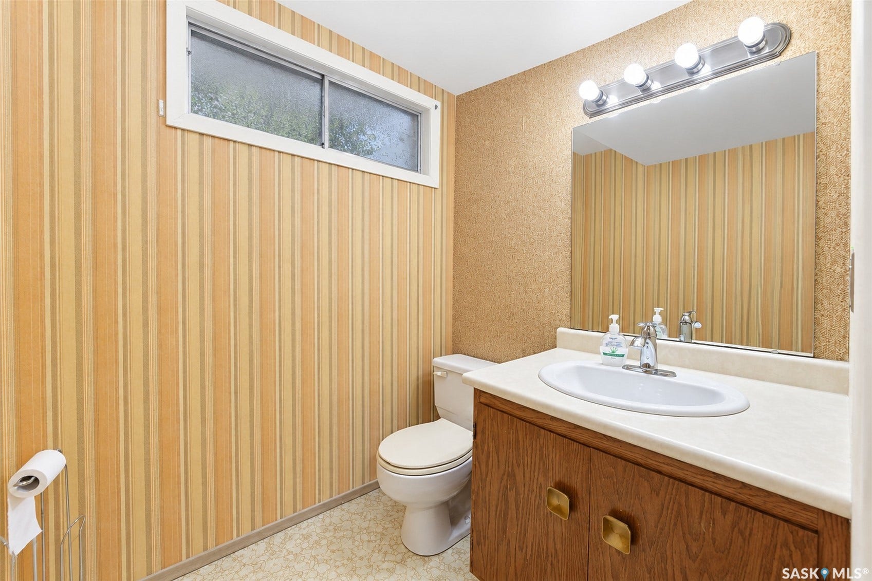 Wood-finish vanity with a white countertop and integrated sink
