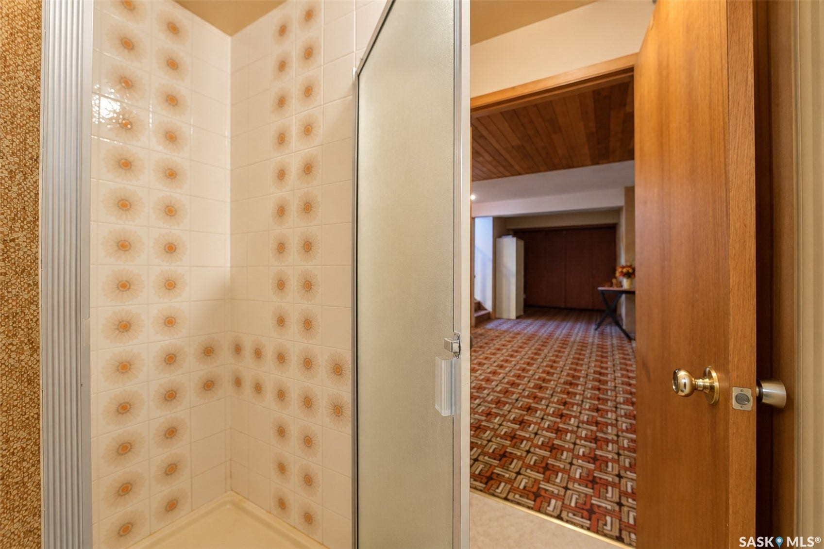 Shower stall with tiled interior walls and a clear glass door